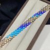 van-cleef-arpels-bouton-dor-bracelet-yellow-gold-turquoise-and-lapis-lazuli-vcaro6w400